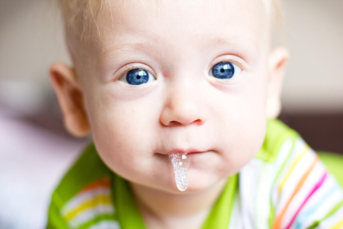 saliva flowing from baby boy's mouth 
